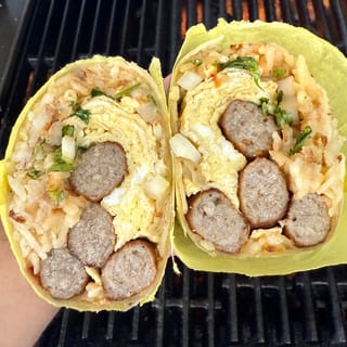 Sausage Breakfast Burrito — 3 eggs, 4 sausage pieces; 1 packed hot-dog tray hash browns